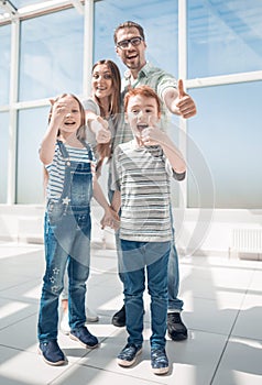 Happy family showing thumbs up