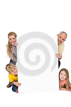 Happy family showing white card