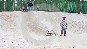happy family sister girl kid pulling sled sledding slide laughing little brother kids children running in snow cheerful