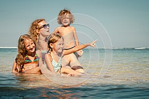 Happy family sitting on the beach