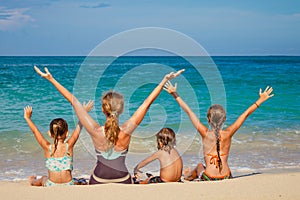 Happy family sitting on the beach