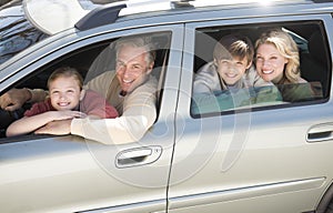 Happy Family Sitting In Car