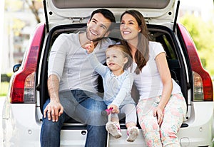 Happy family sitting in car