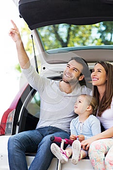 Happy family sitting in car