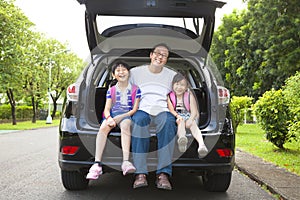 Happy family sitting in the car