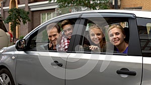 Happy family sitting in car and smiling into camera, automobile buying service