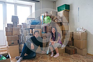 Happy family sitting on the floor in new home photo