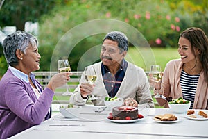 Happy family and sitting with food or lunch together outdoors for celebration or birthday party in retirement. Woman and