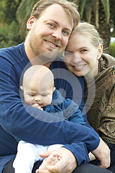 Happy family sitting in the garden