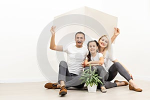 happy family sitting together and making the home sign