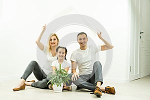 happy family sitting together and making the home sign