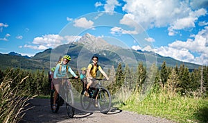 Family with small children cycling outdoors in summer nature. photo