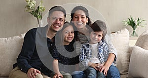 Happy family with small kids posing at home.