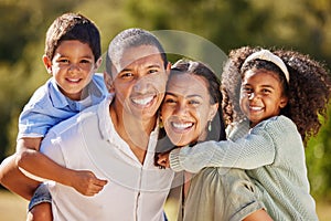 Happy, family and smile of a mom, dad and children in a park in nature having fun in summer. Portrait of parents and