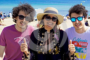 Happy family smiling at camera on the beach in summer vacation in Turkey