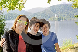 Happy family smiling at camera in lake bled ,Slovenia