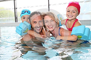 Happy family spending good time in pool