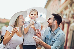 Happy family spending their weekend with son. They are eating the ice-cream