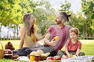 Happy family spending time on holiday. mother, father and little son having picnic in nature on a summer day. Leisure, summer,