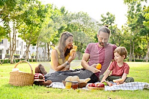 Happy family spending time on holiday. mother, father and little son having picnic in nature on a summer day. Leisure, summer,