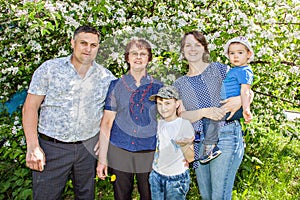 Happy family spending time outdoors on a Sunny summer day. mom, dad ,grandma and two boys