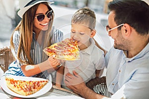 Happy family spending time in pizzeria