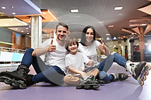 Happy family spending time at roller rink