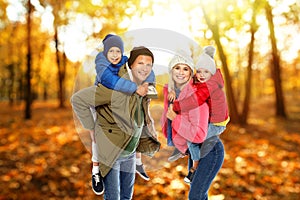 Happy family spending time together at autumn park