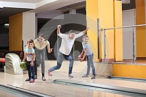 Happy family spending time together in bowling