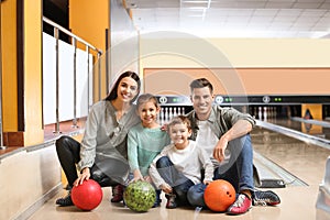 Happy family spending time together in bowling