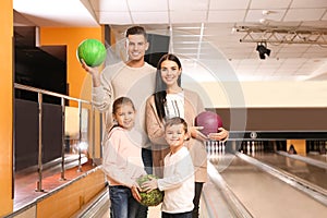 Happy family spending time together in bowling