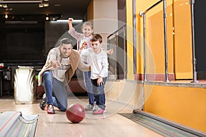 Happy family spending time together in bowling