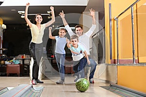 Happy family spending time together in bowling