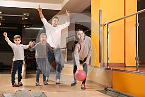 Happy family spending time together in bowling