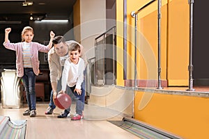 Happy family spending time together in bowling