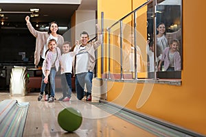 Happy family spending time together in bowling