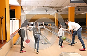 Happy family spending time together in bowling