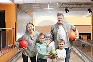 Happy family spending time together in bowling