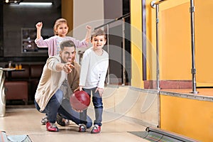 Happy family spending time together in bowling