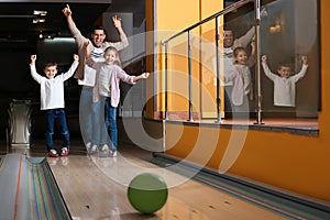 Happy family spending time together in bowling