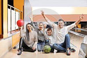 Happy family spending time together in bowling