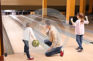 Happy family spending time together in bowling