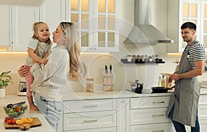 Happy family spending time together while cooking in kitchen