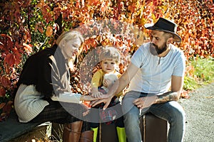 Happy family spending time together outdoor. Lifestyle capture, rural cozy scene. Father, mother and son walking in