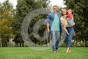 Happy family spending time together in park on sunny summer day