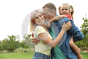 Happy family spending time together in park on sunny summer day