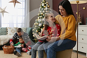 Happy family spending time together in room decorated for Christmas