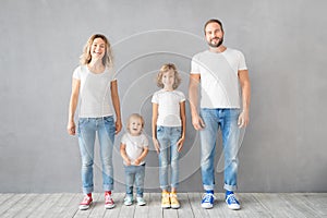 Happy family standing against grey background