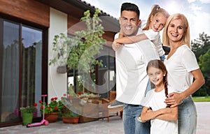 Happy family standing in front of house on sunny day