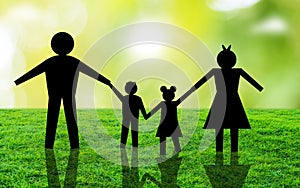 Happy Family standing On Grass Ageist Nature Blur Background. Paper Connected family silhouette in front of sun light
